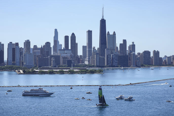 In this image provided by SailGP, Australia SailGP Team helmed by Tom Slingsby sail past the Chicago skyline ahead of United States Sail Grand Prix sailing race on Lake Michigan, Saturday, June 18, 2022, in Chicago. (Simon Bruty/SailGP via AP)