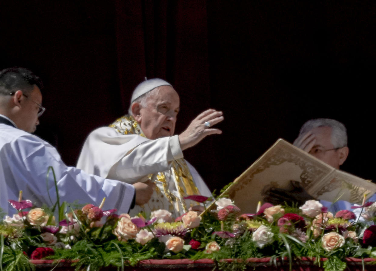 Pope Francis bestows the plenary 'Urbi et Orbi' (to the city and to the world) blessing from the central lodge of the St. Peter's Basilica at The Vatican at the end of the Easter Sunday mass, Sunday, April 9, 2023. (AP Photo/Alessandra Tarantino)