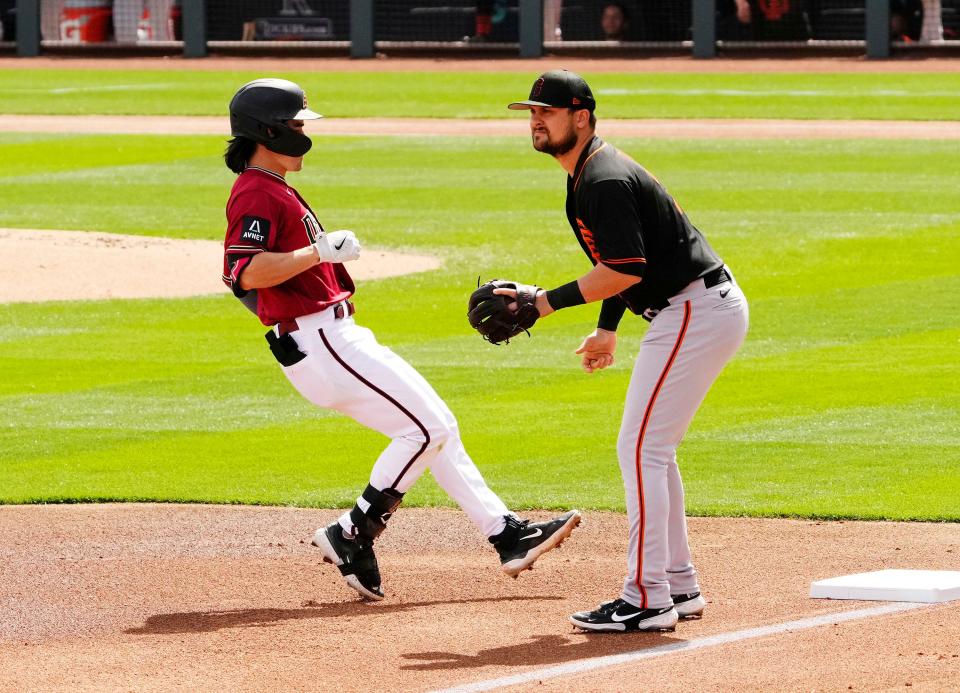 Mar 14, 2023; Scottsdale, AZ, USA; Arizona Diamondbacks Corbin Carroll (7) pulls-up a third base after hitting a triple against the San Francisco Giants in the first inning during a spring training game at Salt River Fields. Mandatory Credit: Rob Schumacher-Arizona Republic