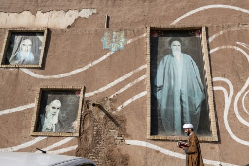 A Muslim Shiite cleric walks past the house of the late founder of the Islamic Republic, Ayatollah Ruhollah Khomeini, in the holy city of Qom