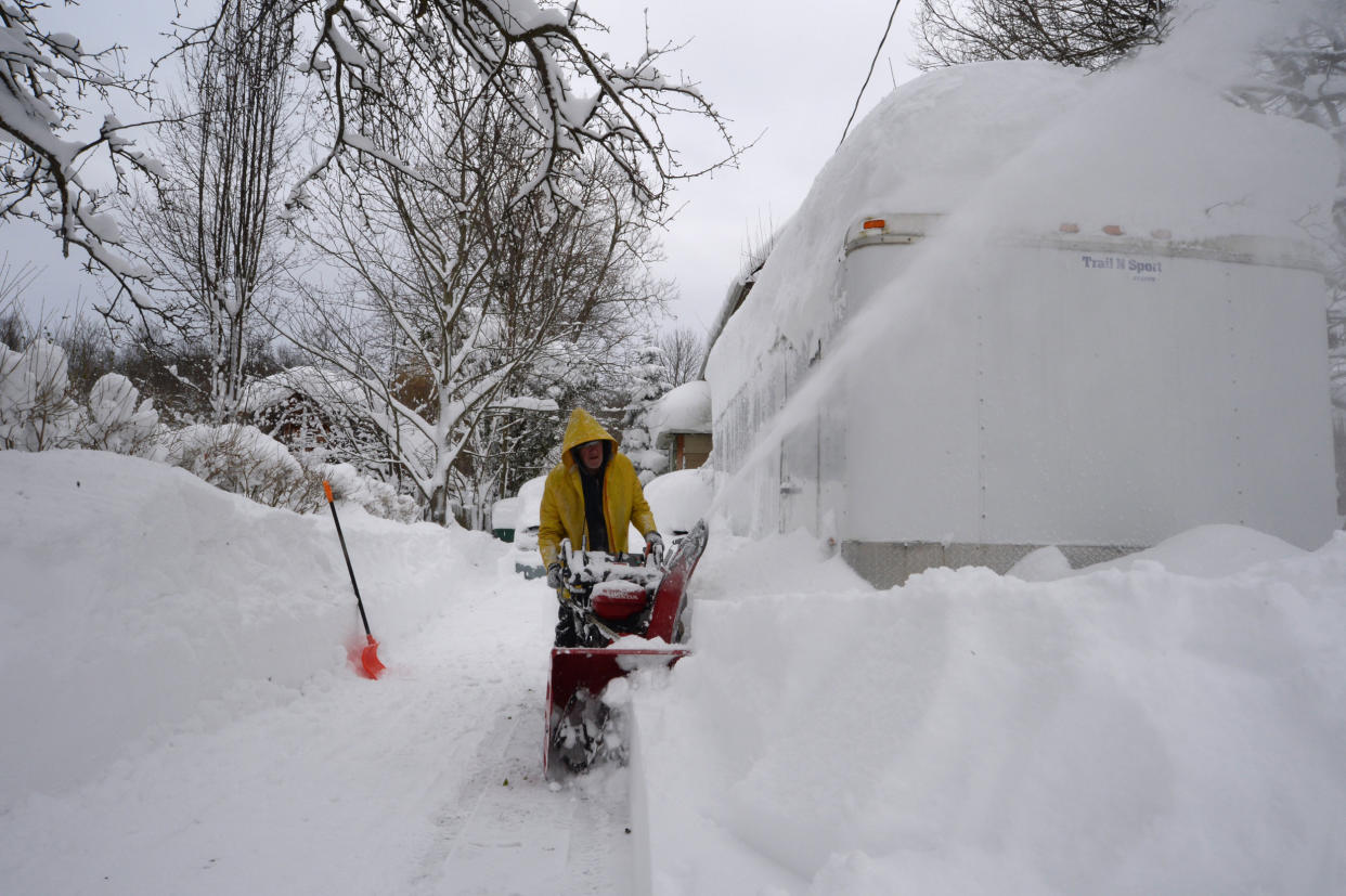 Paul Daruszka clears his driveway in Hamburg, N.Y., on Dec. 26, 2022.  (John Normile / Getty Images)