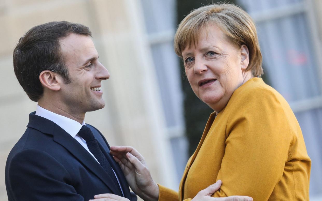 Emmanuel Macron and Angela Merkel at the Elysee Palace in Paris in February. - AFP/AFP