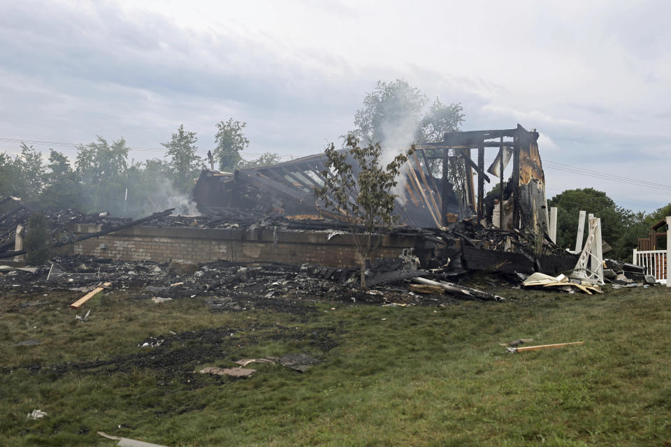 The ruins of a home that was destroyed in an explosion stands at the intersection of Rustic Ridge and Brookside drives in Plum, Pa., on Saturday, Aug. 12, 2023. (Samuel Long/Pittsburgh Post-Gazette via AP/Pittsburgh Post-Gazette via AP)