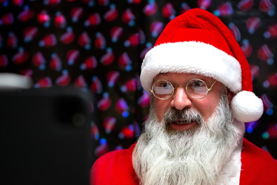 The Zoom screen reflects in Santa Claus' eyeglasses during a Zoom with Santa session.