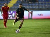 Netherlands' Memphis Depay scores his side's opening goal from penalty during the World Cup 2022 group G qualifying soccer match between Montenegro and Netherlands, at the City stadium in Podgorica, Montenegro, Saturday, Nov. 13, 2021. (AP Photo/Risto Bozovic)