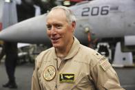 In this Tuesday, March 21, 2017 photograph, Rear Adm. Kenneth Whitesell, commander of Carrier Strike Group 2, speaks to journalists on board the USS George H.W. Bush as it travels through the Persian Gulf. The arrival of the nuclear-powered aircraft carrier to the Persian Gulf marks the first such deployment under new U.S. President Donald Trump. (AP Photo/Jon Gambrell)