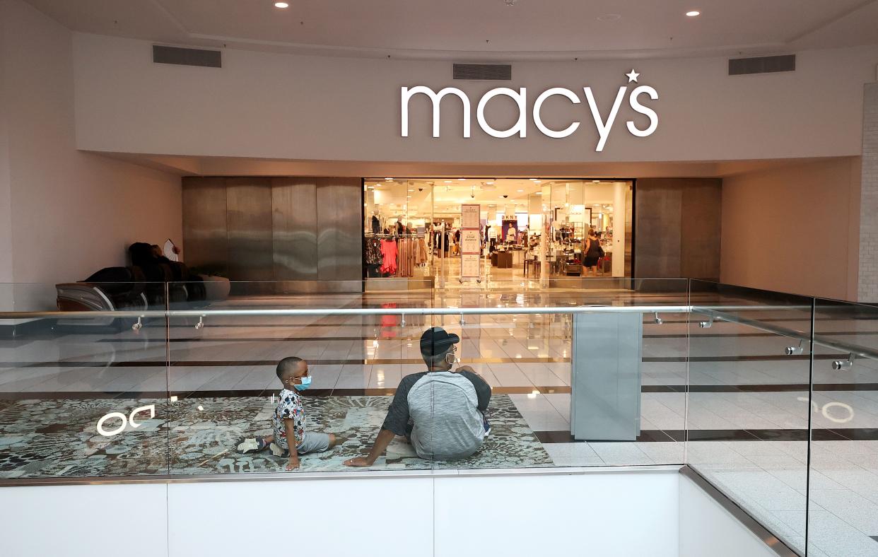 Customers sit outside Macy's department store at Roosevelt Field Mall on July 10, 2020 in Garden City, New York.