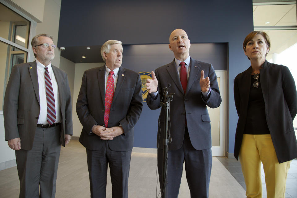 Iowa Gov. Kim Reynolds, right, Nebraska Gov. Pete Ricketts, second right, Missouri Gov. Mike Parson, and Kansas Lt. Gov. Lynn Rogers, left, face reporters following a meeting in Council Bluffs, Iowa, Friday, April 26, 2019, with officials from the U.S. Army Corps of Engineers and the Federal Emergency Management Agency to discuss the aftermath of the recent flooding along the Missouri River. (AP Photo/Nati Harnik)