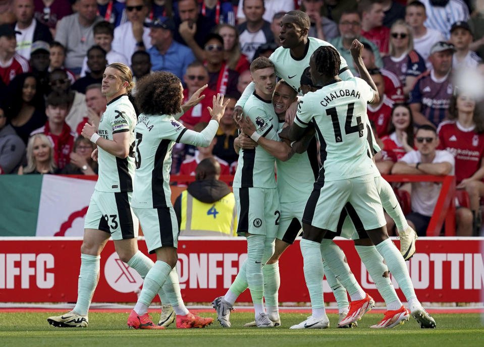 Chelsea's Mykhaylo Mudryk, fourth left, is congratulated by his teammates after scoring the opening goal during the English Premier League soccer match between Nottingham Forest and FC Chelsea in Nottingham, England, Saturday, May 11, 2024. (Martin Rickett/PA via AP)