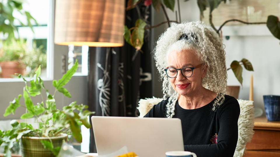 Woman looking down at her laptop to ease dry eye