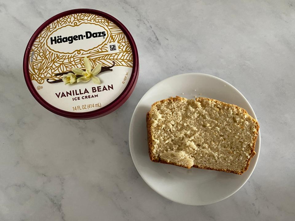 a pint of haagen-daaz vanilla ice cream beside a plated slice of the bread, all on a white countertop