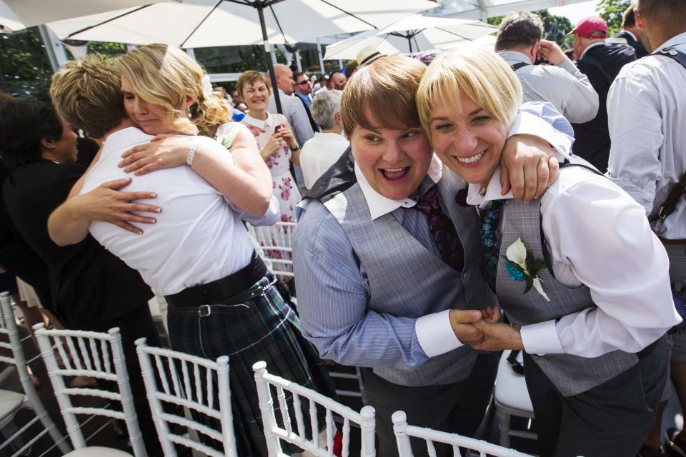 Couples celebrate after the ceremony for "The Celebration of Love", a grand wedding where over 100 LGBT couples got married, at Casa Loma in Toronto