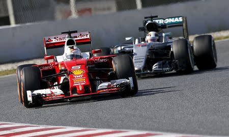 Ferrari Formula One driver Sebastian Vettel takes a curve followed by McLaren Lewis Hamilton during a testing session at Barcelona-Catalunya racetrack in Montmelo, near Barcelona, Spain, March 4, 2016. REUTERS/Albert Gea - RTSAA1H