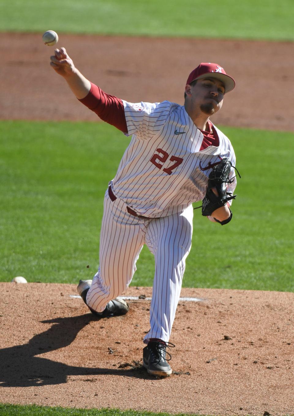 Feb 18, 2023; Bessemer, AL, USA;  Alabama pitcher Ben Hess (27) delivers a pitch as the Crimson Tide faced Richmond in the season-opening series.