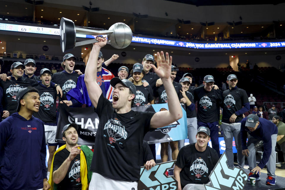 Saint Mary's guard Alex Ducas and teammates celebrate a win over Gonzaga in an NCAA college basketball game for the championship of the West Coast Conference men's tournament Tuesday, March 12, 2024, in Las Vegas. (AP Photo/Ian Maule)