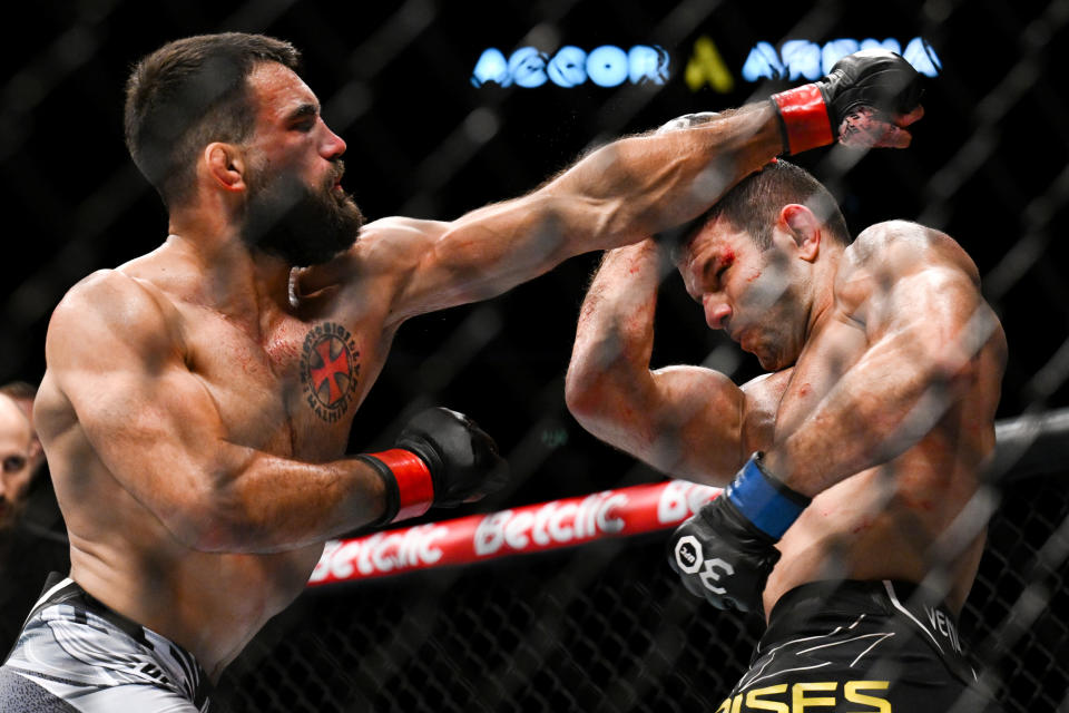 Sep 2, 2023; Paris, France; Benoit Saint-Denis (red gloves) fights Thiago Moises (blue gloves) during UFC Fight Night at Accor Arena. Mandatory Credit: Per Haljestam-USA TODAY Sports