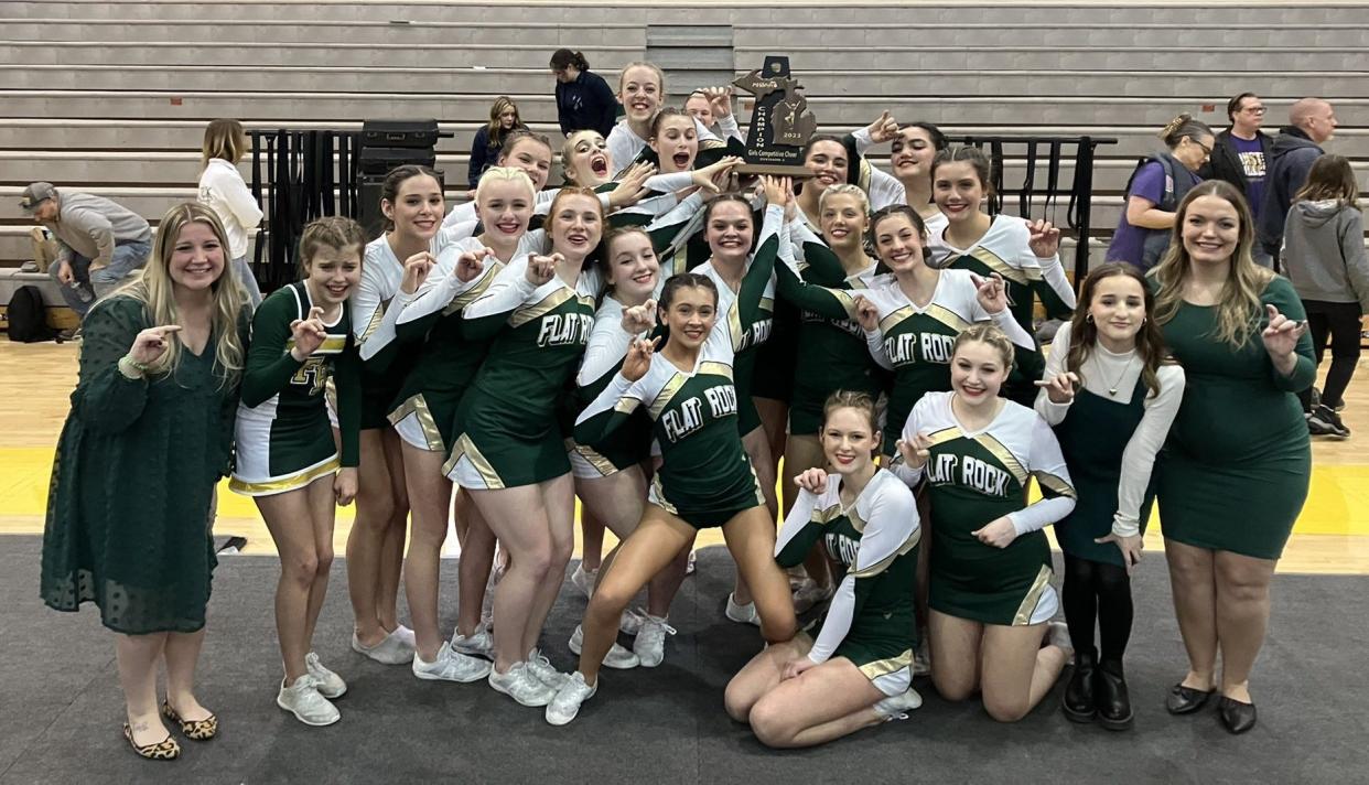 Flat Rock's competitive cheerleading team celebrates the Division 3 District championship it won at home Friday night.