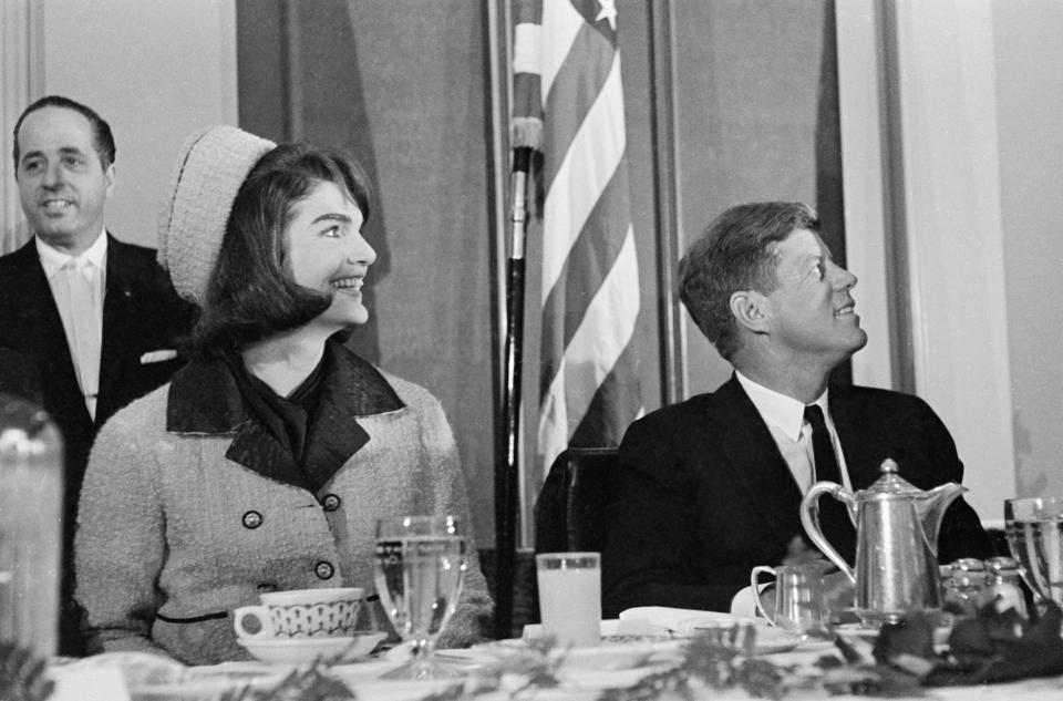 (Original Caption) President John F. Kennedy with his wife, who was introduced at a Chamber of Commerce breakfast, November 22nd. Later in the day, an assassin firing into the President's open car in Dallas hit the President and the Governor of Texas, John Connally.