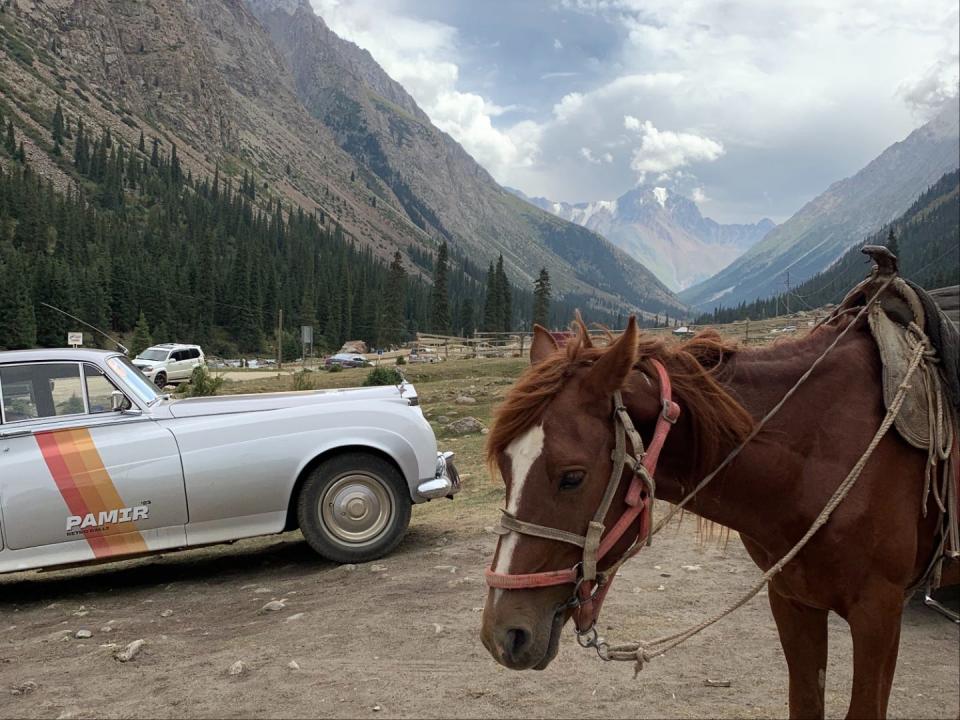 A Rolls Royce silvercloud on the left, and a horse on the right near Bishkek, in Kyrgyzstan.