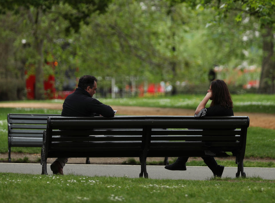 People observing social distancing on a bench in Hyde Park, London, as the UK continues in lockdown to help curb the spread of the coronavirus.