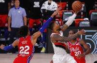 Portland Trail Blazers' Damian Lillard shoots next to Philadelphia 76ers' Matisse Thybulle, left, during the fourth quarter of an NBA basketball game Sunday, Aug. 9, 2020, in Lake Buena Vista, Fla. (Kevin C. Cox/Pool Photo via AP)