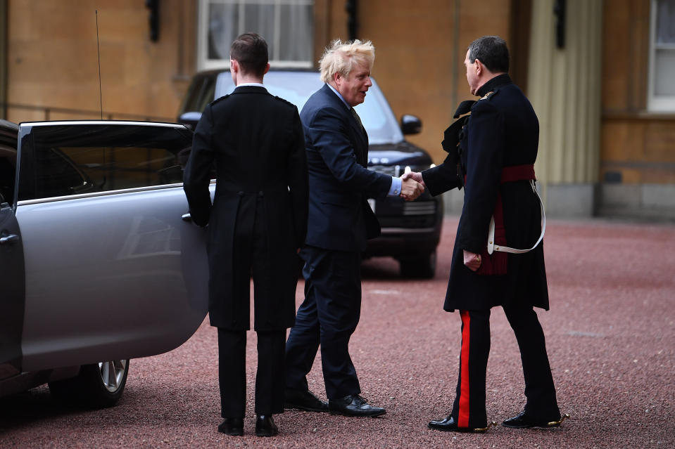 Boris Johnson was greeted by The Queen's Equerry, Major Nana Kofi Twumasi-Ankrah, as he arrived at Buckingham Palace to ask the Queen for permission to form a government (Picture: PA)