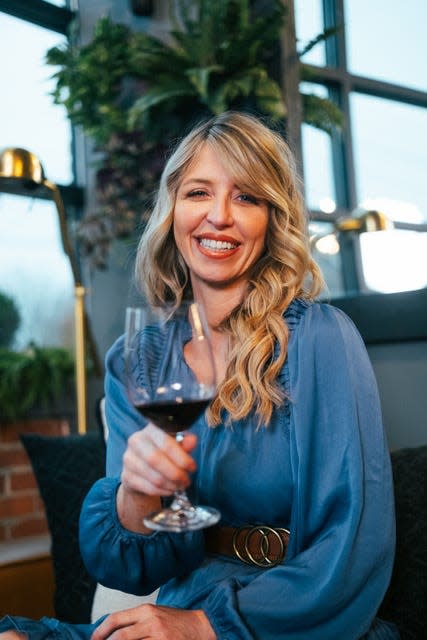 Carly Buntin poses in Claywood, a new wine and whiskey restaurant that is now open in downtown Hendersonville.
