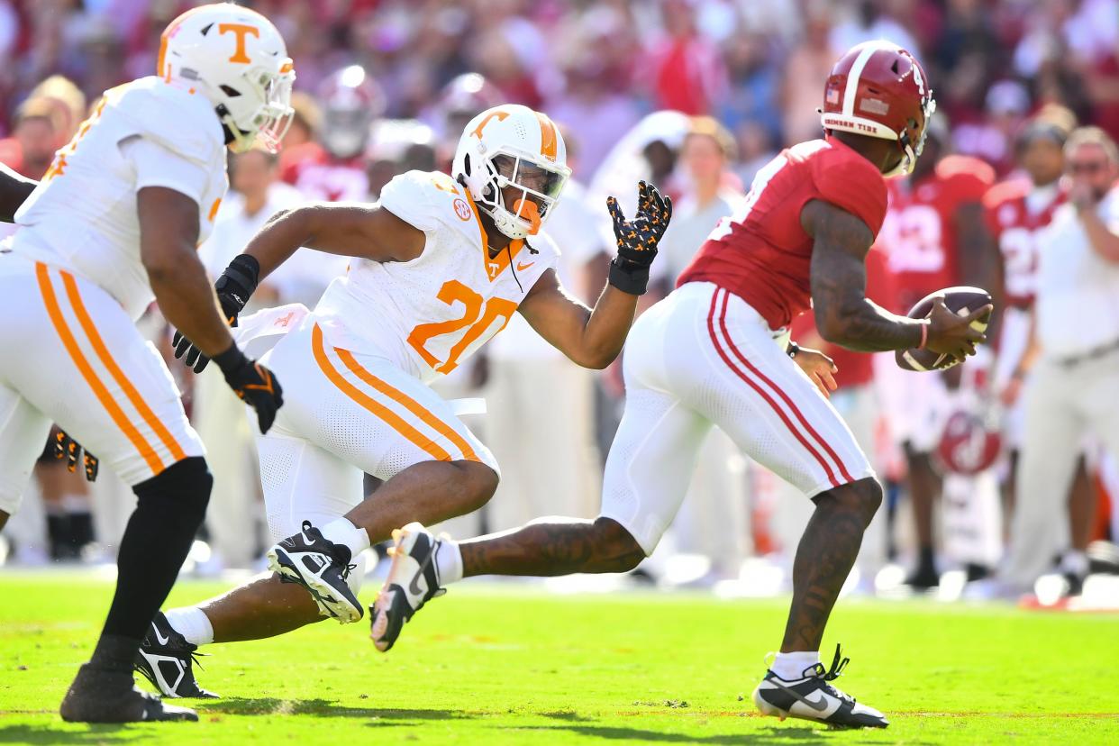 Alabama quarterback Jalen Milroe (4) is pressured by Tennessee defensive lineman Bryson Eason (20) during a football game between Tennessee and Alabama at Bryant-Denny Stadium in Tuscaloosa, Ala., on Saturday, Oct. 21, 2023.