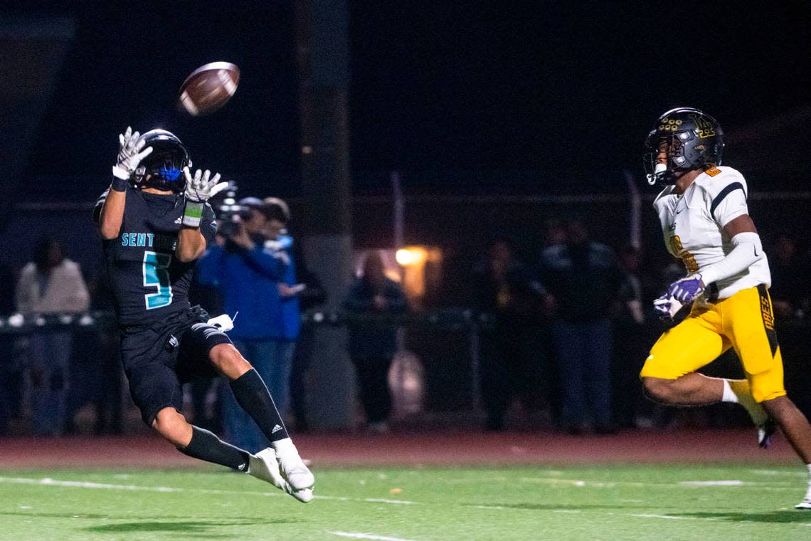 Spanaway Lake’s Zion Jones catches a touchdown pass from quarterback Dempsy James as Lincoln’s John John Nelson defends during the second quarter of a 3A PCL game on Friday, Oct. 28, 2022, at Art Crate Field in Spanaway, Wash.
