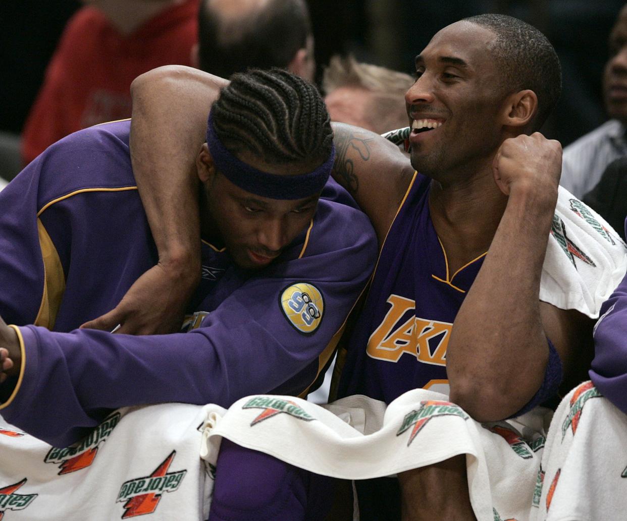 Los Angeles Lakers' Kobe Bryant, right, reacts with teammate Kwame Brown during the second half of basketball action at New York's Madison Square Garden in 2006. Bryant scored 40 points as the Lakers won the game 130-97.