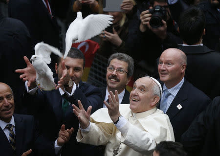 Pope Francis releases a white dove prior to delivering a Holy Mass at the Catholic Cathedral of the Holy Spirit in Istanbul November 29, 2014. REUTERS/Stoyan Nenov