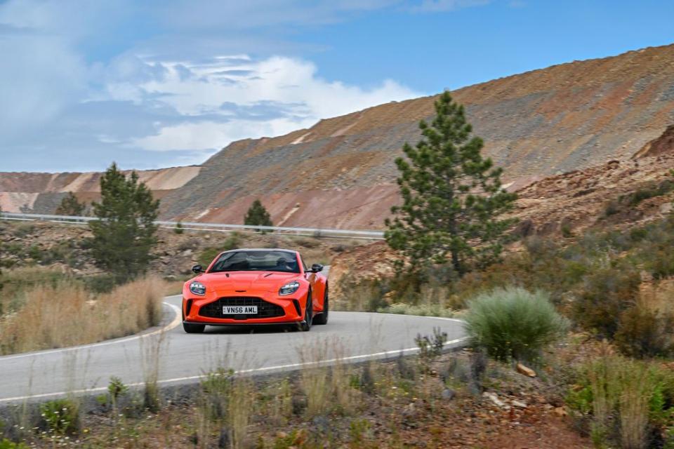 a red car driving on a road