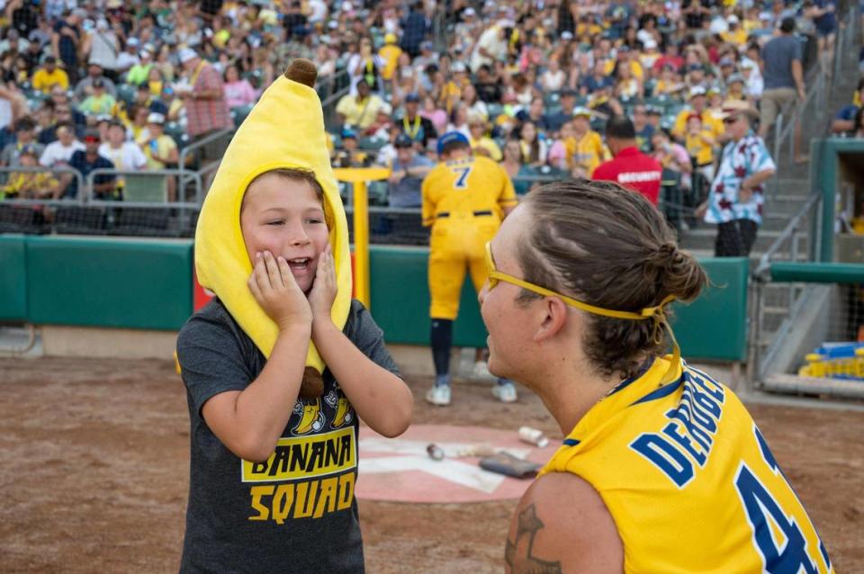 Walter Simmons, 7, talks with Savanna Bananas’ Vincent DeRubeis (41) before participating in a fan challenge during the Savannah Bananas World Tour on Saturday, July 29, 2023, at Sutter Health Park in West Sacramento.