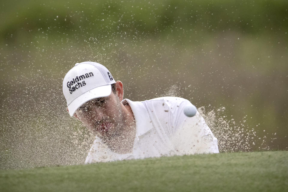 Patrick Cantlay watches his shot out a bunker on the 18th green during a one-hole play off with Jordan Spieth at the RBC Heritage golf tournament, Sunday, April 17, 2022, in Hilton Head Island, S.C. (AP Photo/Stephen B. Morton)