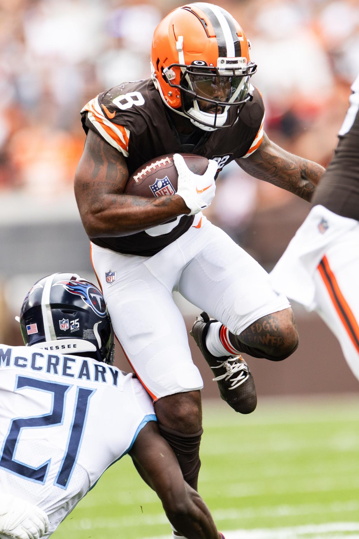 Browns wide receiver Elijah Moore tries to elude Titans cornerback Roger McCreary in the first quarter, Sept 24, 2023, in Cleveland.