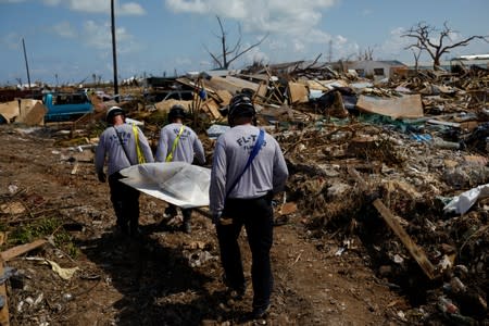 Personnel from the Florida Search & Rescue Task Force remove a body recovered in the destroyed the Mudd neighbourhood after Hurricane Dorian hit the Abaco Islands in Marsh Harbour