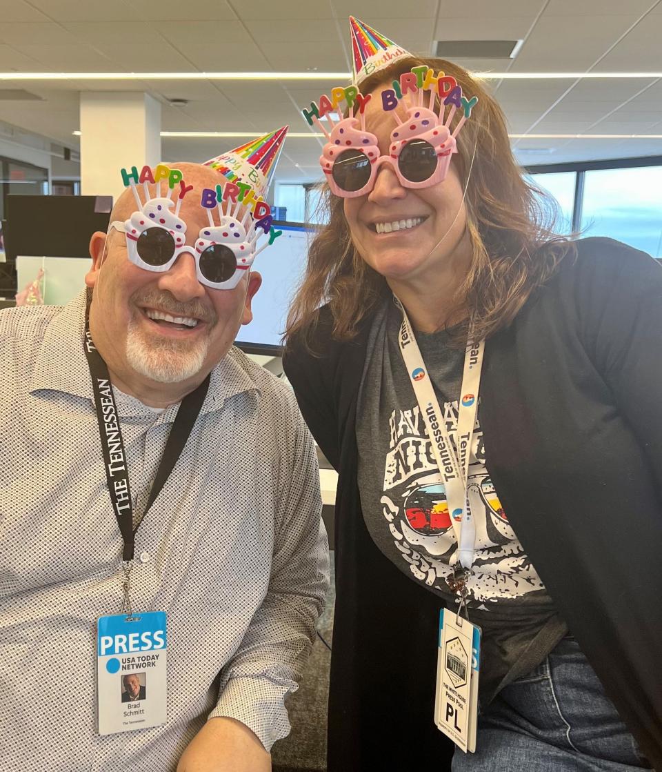 Tennessean writers Brad Schmitt and Kelly Puente, whose birthdays are a day apart, pose after Tennessean "Aggressively Festive Editor" Nicole Young decorated them and their desks in the newsroom at 1801 West End Ave., on Aug. 10, 2023