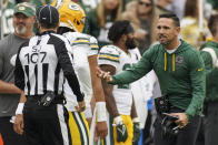 Side judge Dave Hawkshaw (107) listens to Green Bay Packers head coach Matt LaFleur during the first half of an NFL football game against the Washington Commanders, Sunday, Oct. 23, 2022, in Landover, Md. (AP Photo/Al Drago)