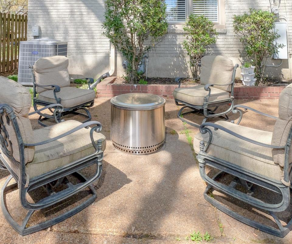 The back patio has modern seating along with a firepit that is perfect when entertaining under the stars.