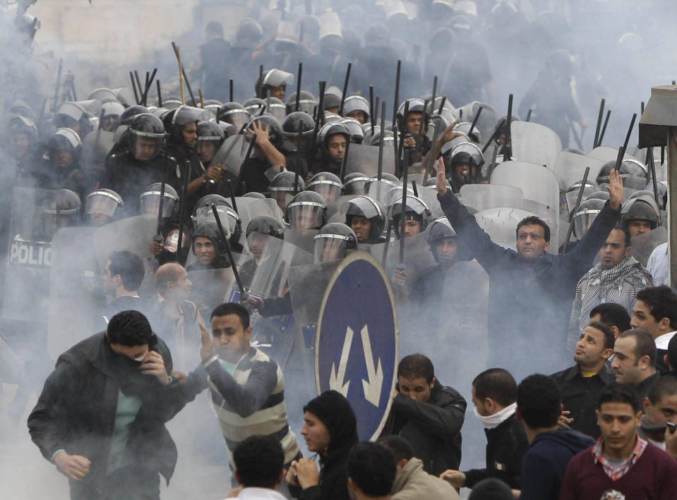 FILE - In this Jan. 28, 2011 file photo, anti-government activists clash with riot police in Cairo, Egypt, to challenge President Hosni Mubarak's 30-year rule. Ten years ago, an uprising in Tunisia opened the way for a wave of popular revolts against authoritarian rulers across the Middle East known as the Arab Spring. For a brief window as leaders fell, it seemed the move toward greater democracy was irreversible. Instead, the region saw its most destructive decade of the modern era. (AP Photo/Ben Curtis)