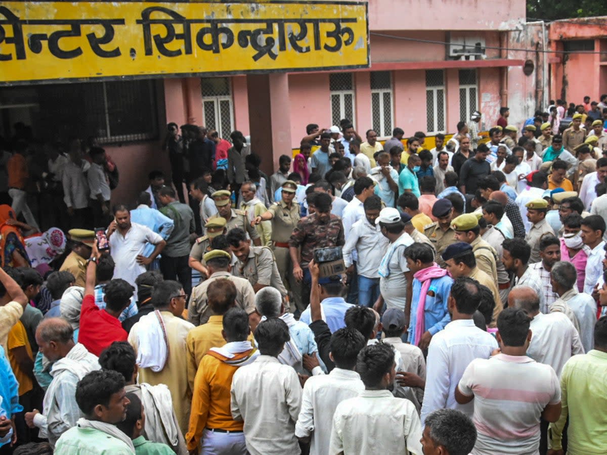 Relatives of victims of the Hathras stampede gather outside a hospital in Uttar Pradesh state on 2 July 2024  (Getty)