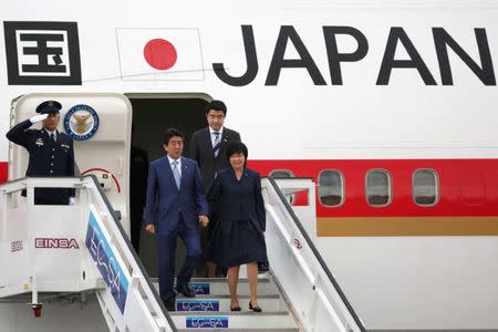 Japan's Prime Minister Shinzo Abe and his wife Akie arrive at the Jose Marti International Airport in Havana, Cuba, September 22, 2016. REUTERS/Alexandre Meneghini