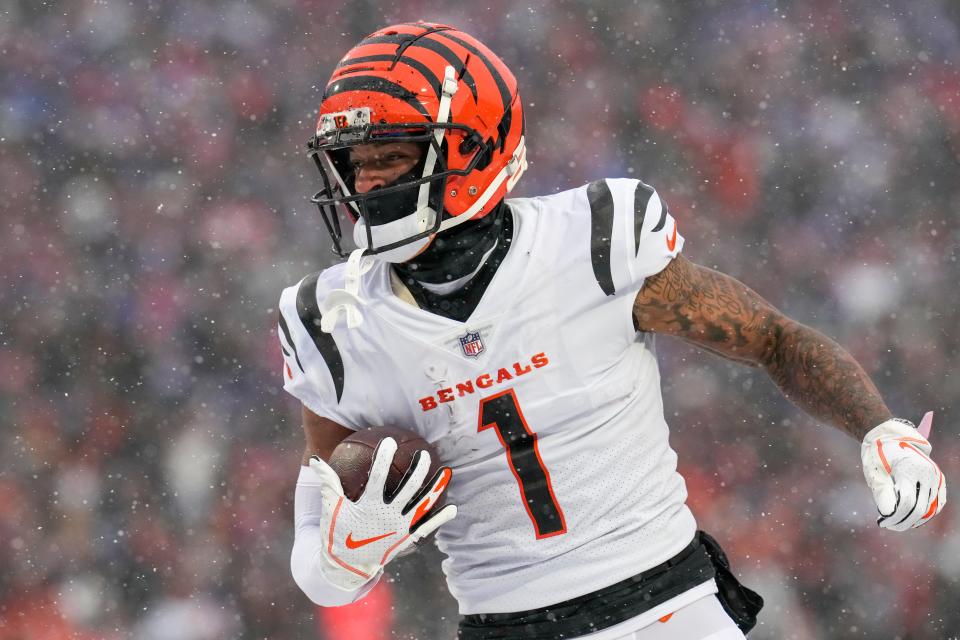 Cincinnati Bengals wide receiver Ja'Marr Chase (1) runs through the endzone with a touchdown reception in the first quarter of Sunday's game against the Buffalo Bills.
