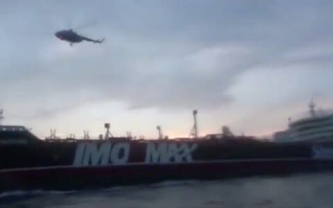 A helicopter hovers over British-flagged tanker Stena Impero near the strait of Hormuz - Credit: Reuters