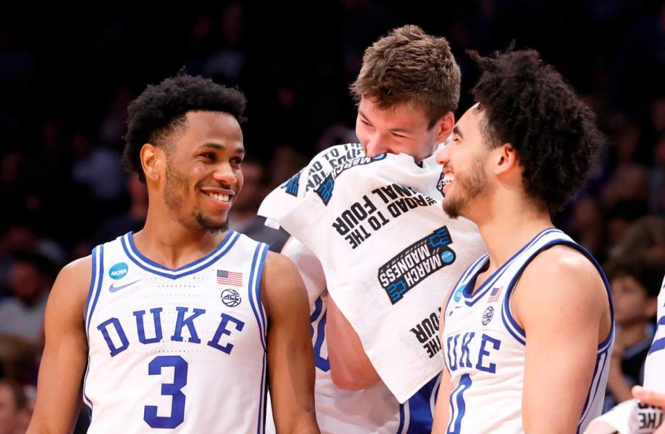 Duke’s Kyle Filipowski (30) laughs with Jeremy Roach (3) and Jared McCain (0) late in the second half of Duke’s 93-55 victory over James Madison in the second round of the NCAA Tournament at the Barclays Center in Brooklyn, N.Y., Sunday, March 24, 2024.