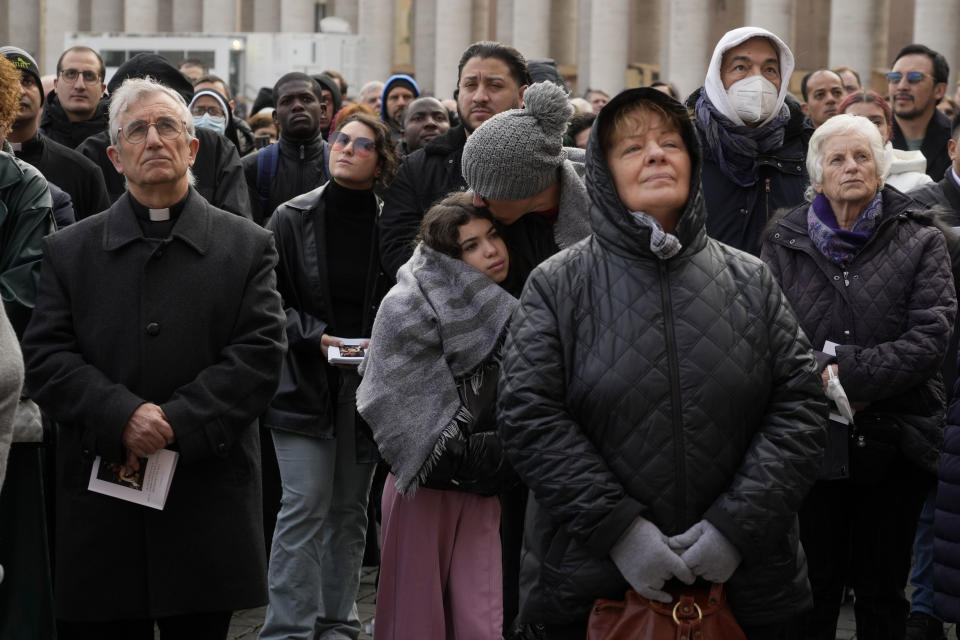 Faithful attend the funeral mass for late Pope Emeritus Benedict XVI in St. Peter's Square at the Vatican, Thursday, Jan. 5, 2023. Benedict died at 95 on Dec. 31 in the monastery on the Vatican grounds where he had spent nearly all of his decade in retirement. (AP Photo/Gregorio Borgia)