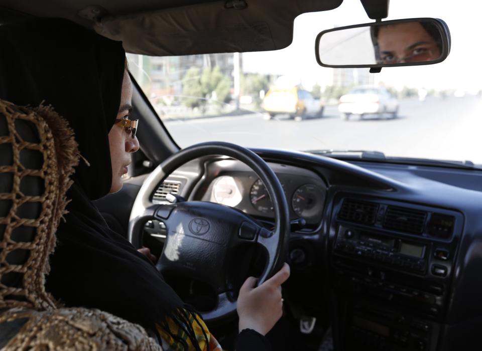 Tahmina drives during a practical driving lesson in Kabul