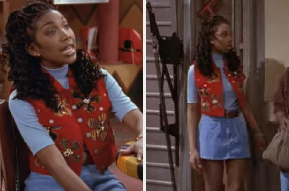 Moesha wearing a denim mini-skirt with a brown belt, a blue turtleneck tshirt and a red floral appliqué vest