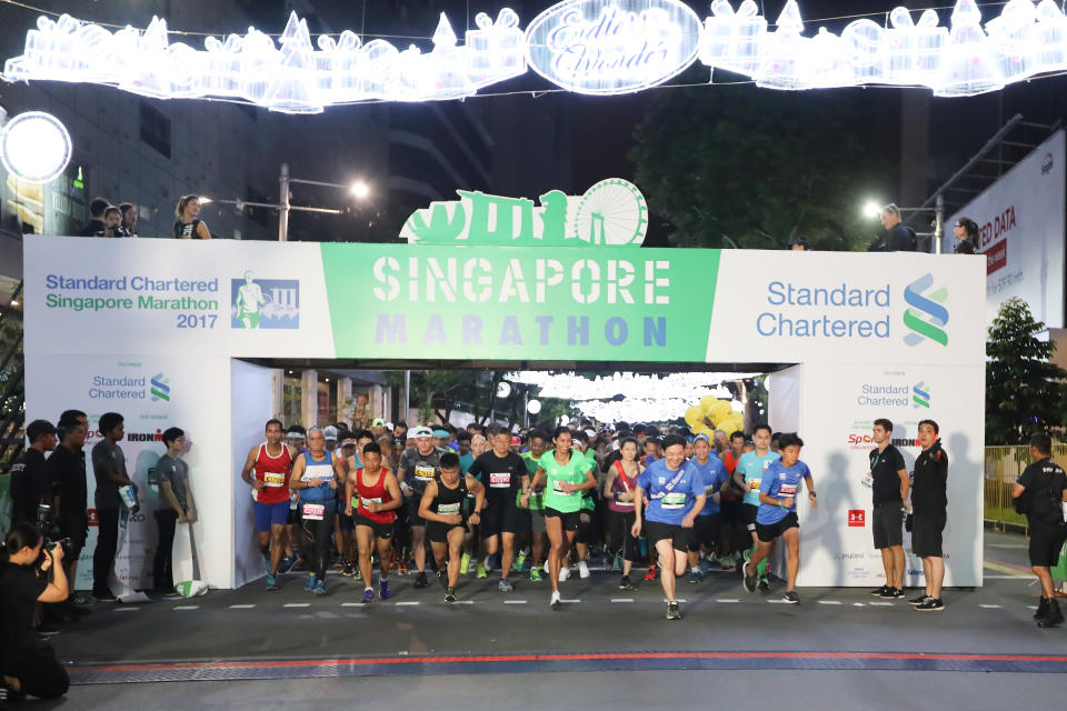 <p>Minister for National Development and Second Minister for Finance in Singapore Lawrence Wong (in blue sash) led fellow ekiden runners at the flag-off of the Standard Chartered Singapore Marathon 2017 this morning along Orchard Road on 3 December 2017.<br /> Photo: Standard Chartered Singapore Marathon 2017 </p>