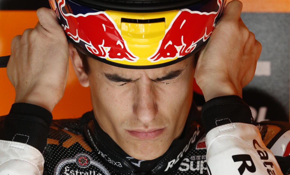 Suter Moto2 rider Marc Marquez of Spain wears his helmet in his pit garage during a free practice session for Sunday's Japanese Grand Prix in Motegi, north of Tokyo October 12, 2012.   REUTERS/Toru Hanai (JAPAN - Tags: SPORT MOTORSPORT)